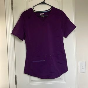 Small, dark purple scrub set with 8 pockets total and cuffed ankles.
